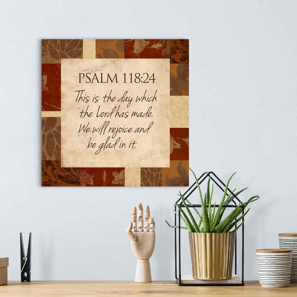 A bohemian room featuring Typographical scripture art with a border make up of different patterns and foliage.