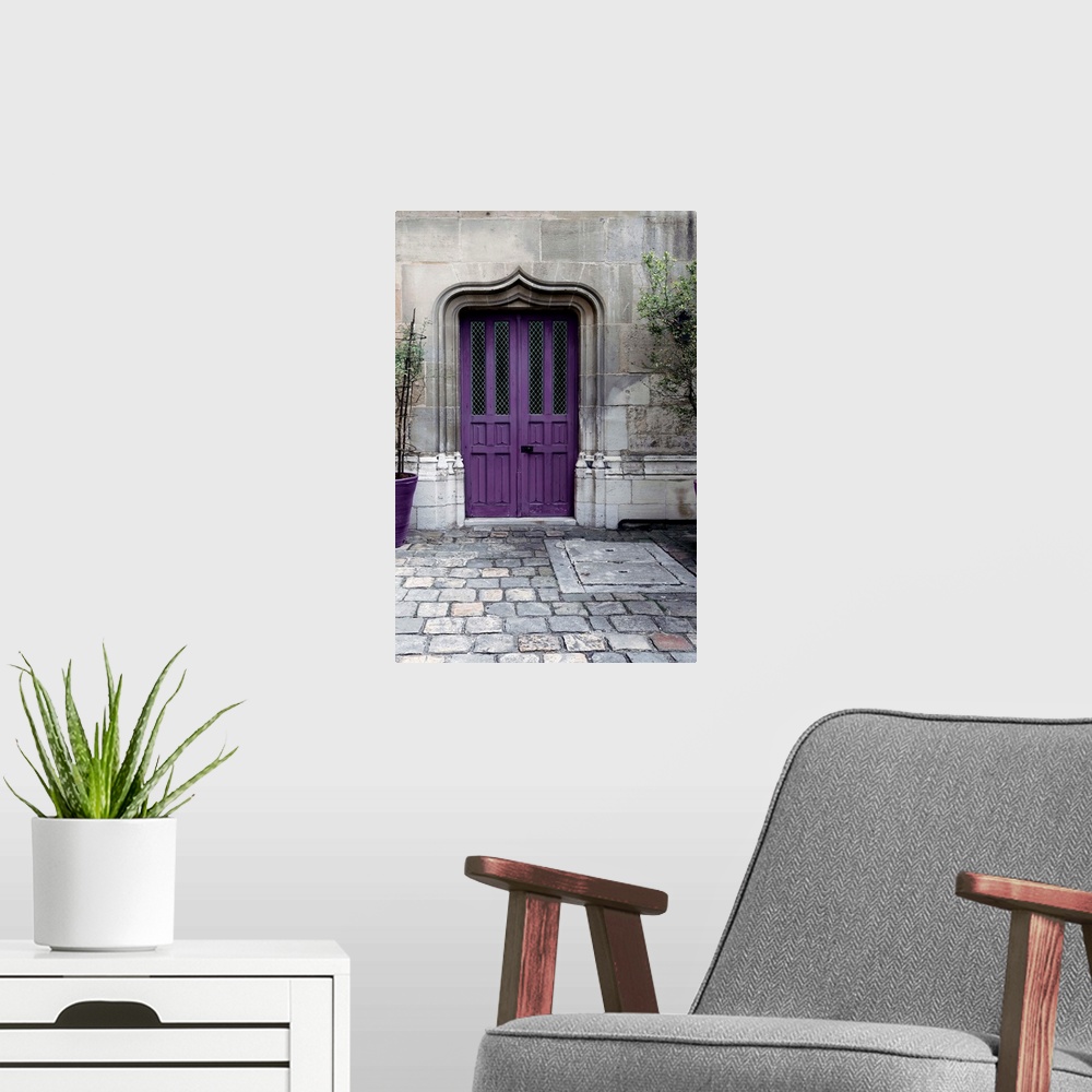 A modern room featuring Fine art photograph of a purple door in a stone wall on a cobblestone street.