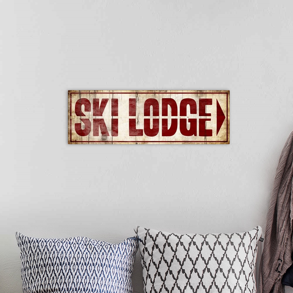 A bohemian room featuring Sign for a Ski Lodge with large red letters.