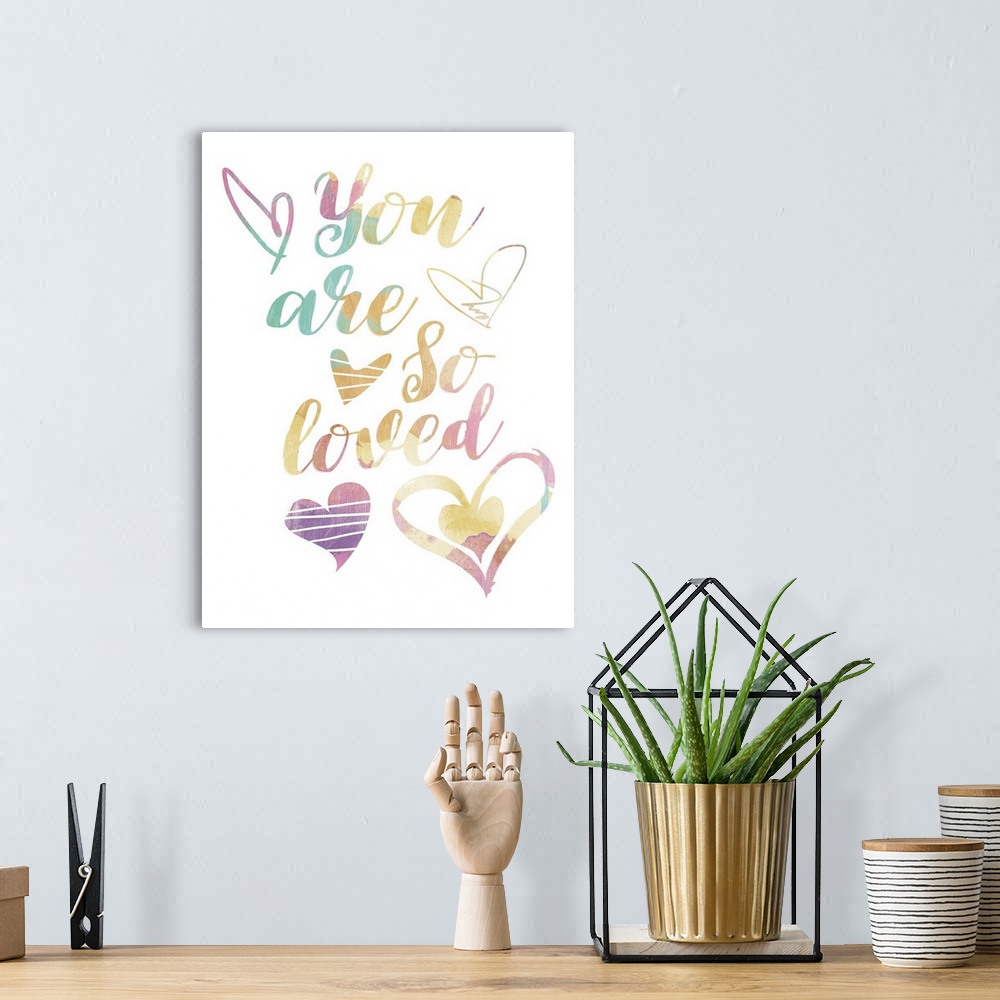 A bohemian room featuring Children's typography artwork in pastel rainbow colors with a heart motif.