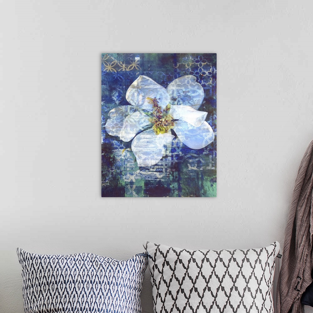 A bohemian room featuring A painting of a single white magnolia flower on a blue and green background with tan designs.