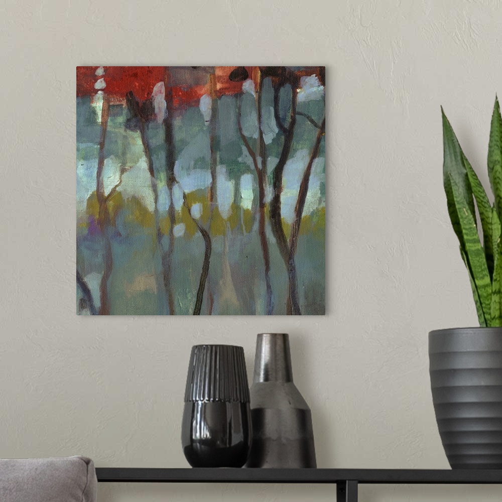 A modern room featuring Contemporary artwork of thin birch trees in a dark forest with bright leaves.