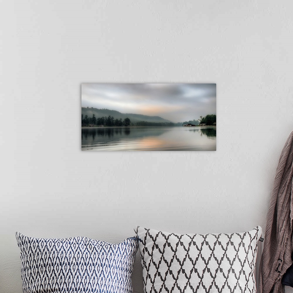 A bohemian room featuring A cloudy sky in the early morning over coastal waters.
