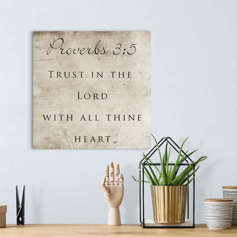 A bohemian room featuring Typography art of the Bible verse Proverbs 3:5.