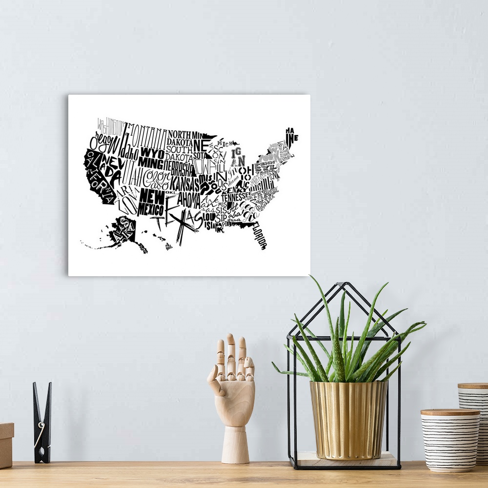 A bohemian room featuring A contemporary typography map of the United States with all the state names in black and white.
