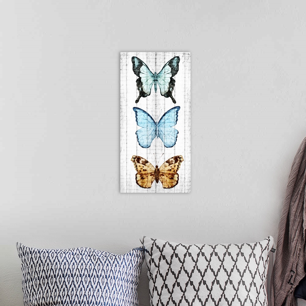 A bohemian room featuring Three butterflies painted vertically on a wooden paneled background with faded handwriting on top.