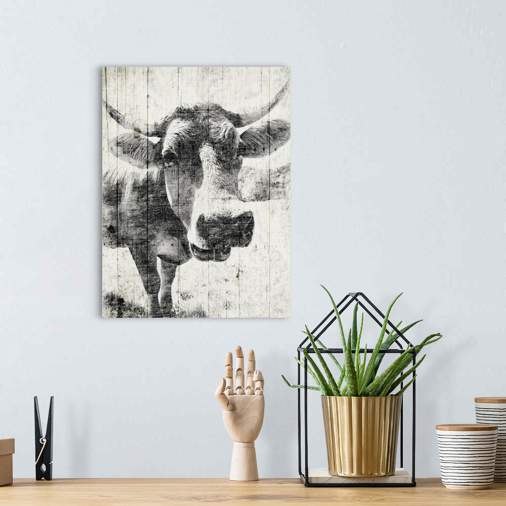 A bohemian room featuring Contemporary artwork of a cow against a background of rustic wood planks.