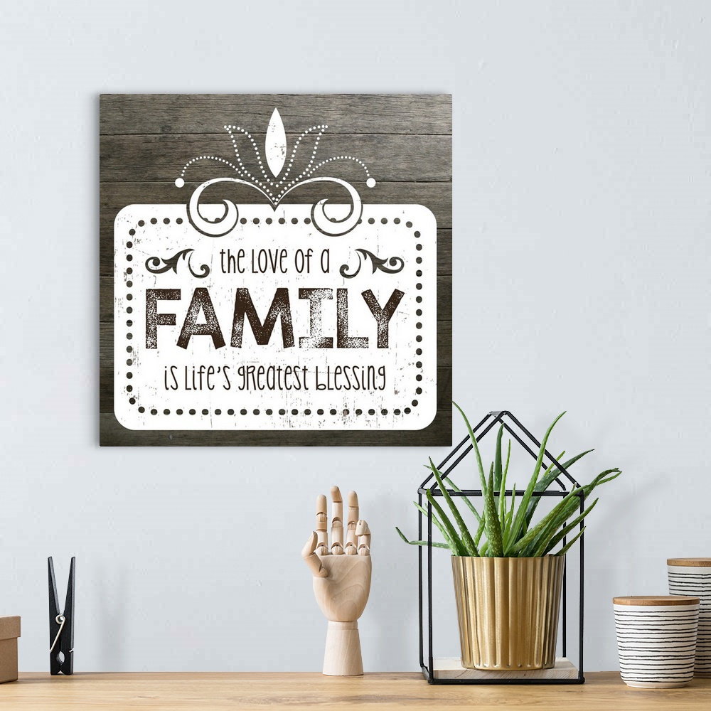 A bohemian room featuring The phrase "The love of a family is life's greatest blessing" on a vintage marquee shape over a f...