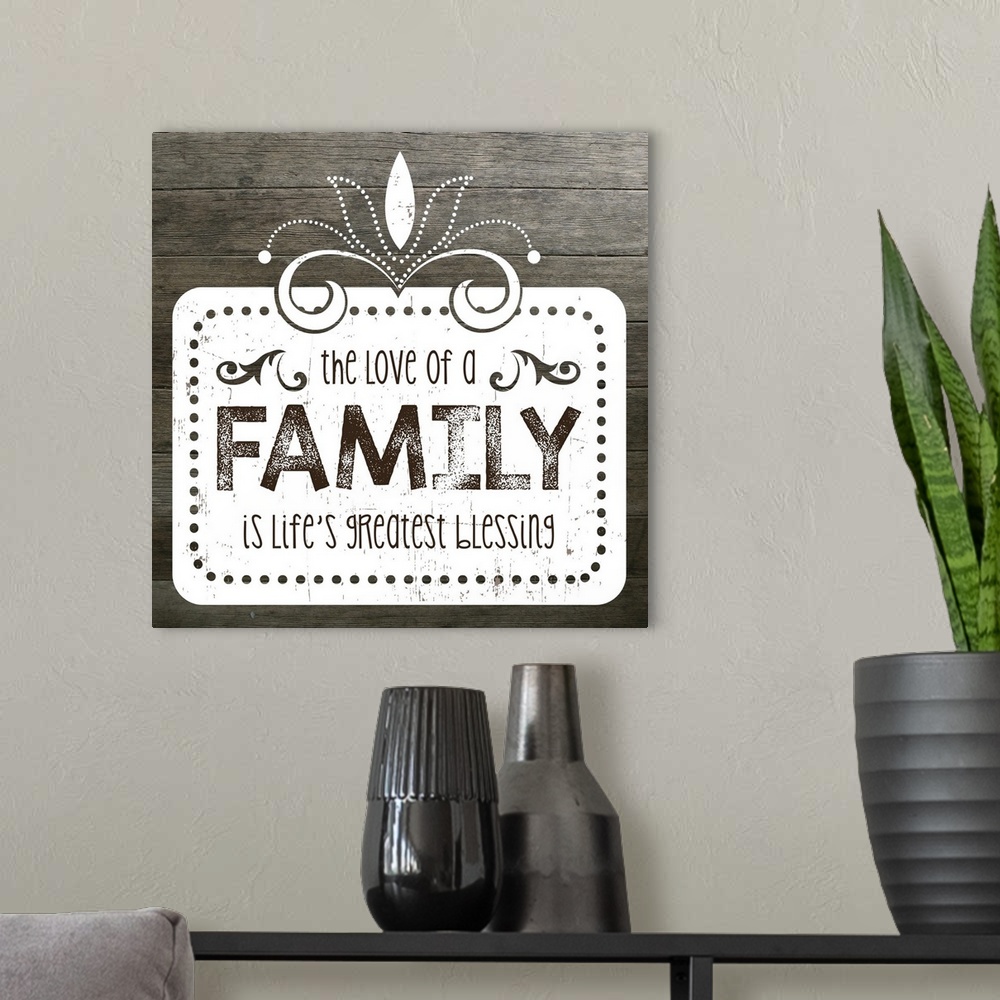 A modern room featuring The phrase "The love of a family is life's greatest blessing" on a vintage marquee shape over a f...