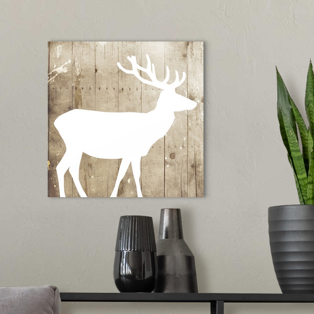 A modern room featuring A white silhouette of a deer painted on a wood background.