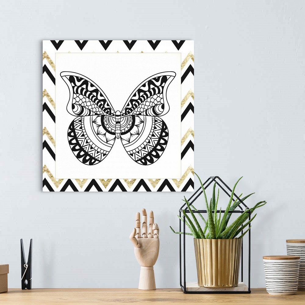 A bohemian room featuring A symmetrical black and gold designed butterfly.