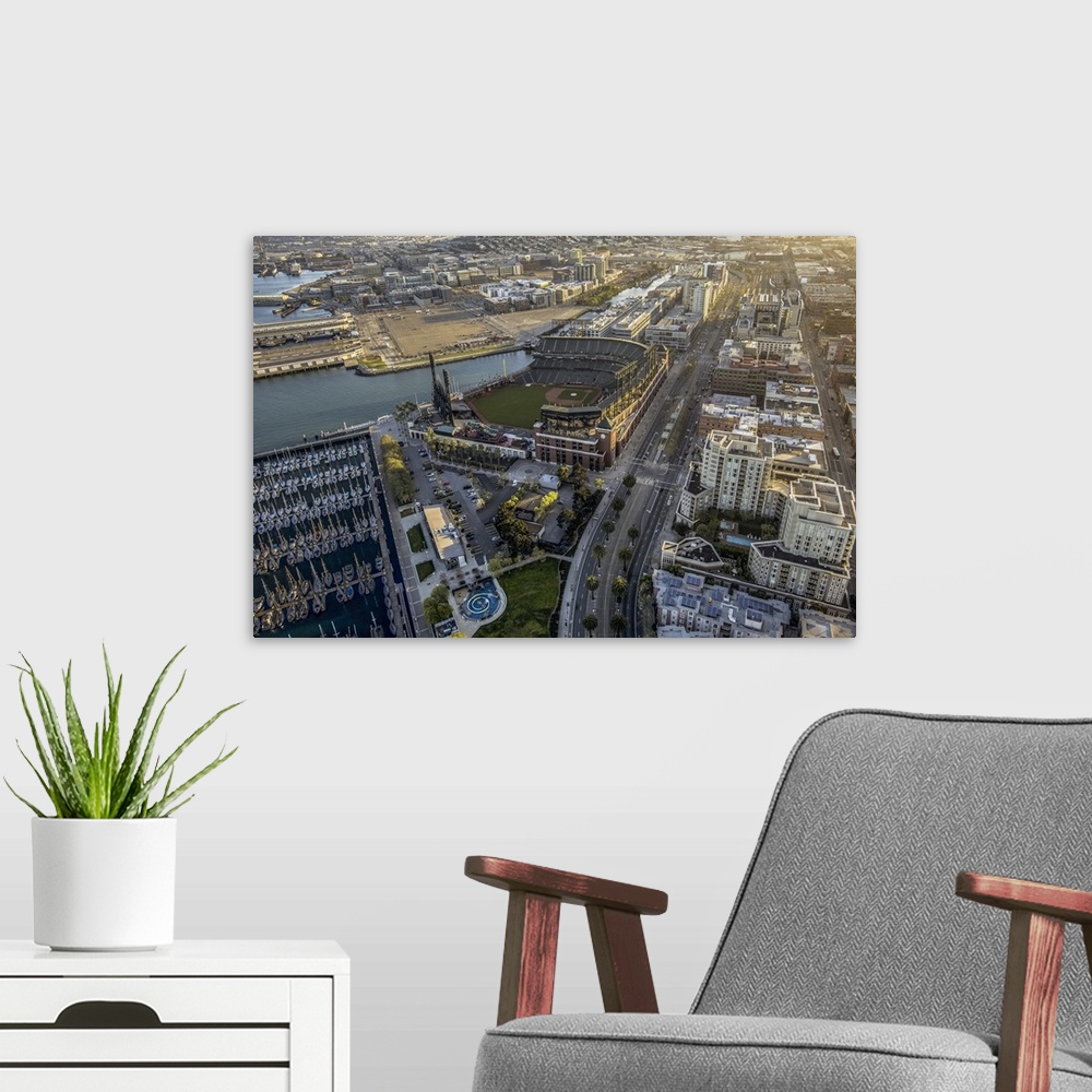A modern room featuring Aerial photograph of the city of San Francisco, with a view of the harbor and AT-T Park.