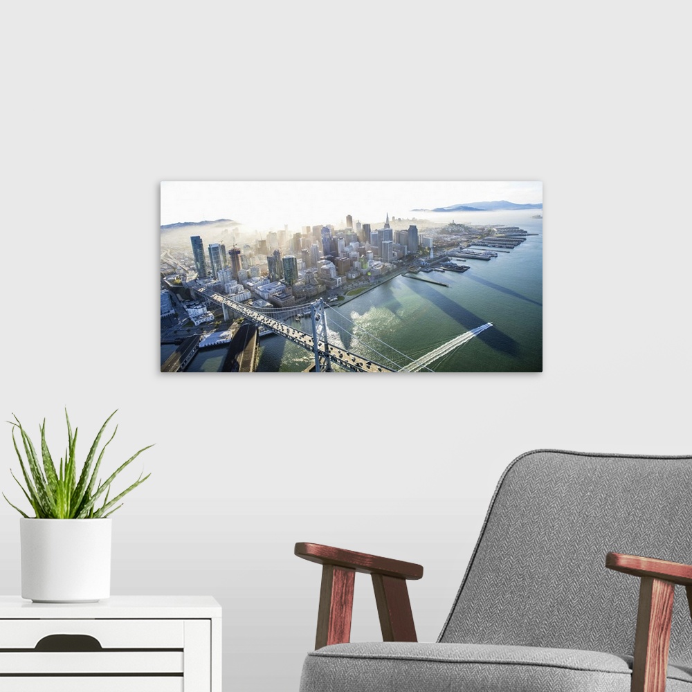 A modern room featuring Aerial photograph of the city of San Francisco with the Bay Bridge in the morning.