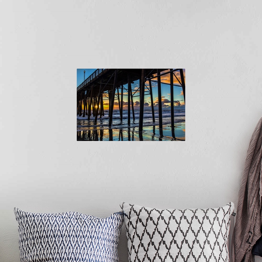A bohemian room featuring The sun peaks through the pilons of the Oceanside Pier. Oceanside is 35 miles North of San Diego,...