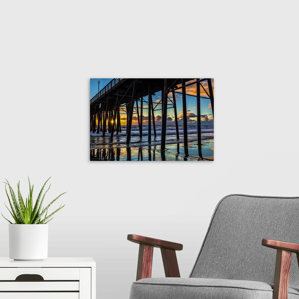 A modern room featuring The sun peaks through the pilons of the Oceanside Pier. Oceanside is 35 miles North of San Diego,...