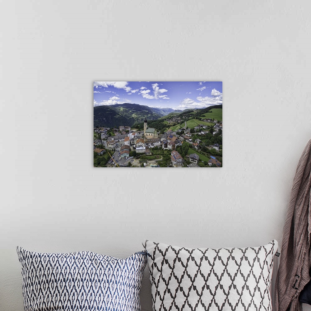 A bohemian room featuring Aerial capture of a church in Vols Am Schlern, Northern Italy.