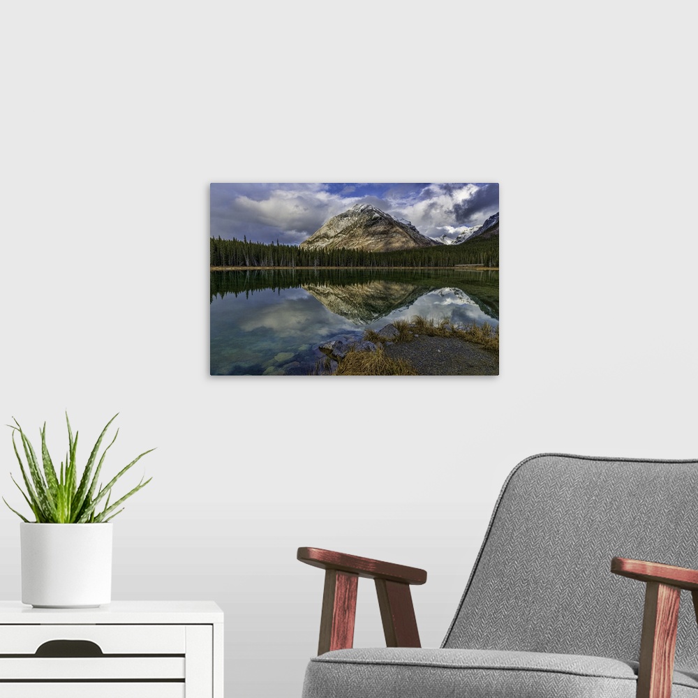A modern room featuring Panoramic reflections at Buller Pond. Snow-capped Buller Mountain in the distance. Alberta, Canada.