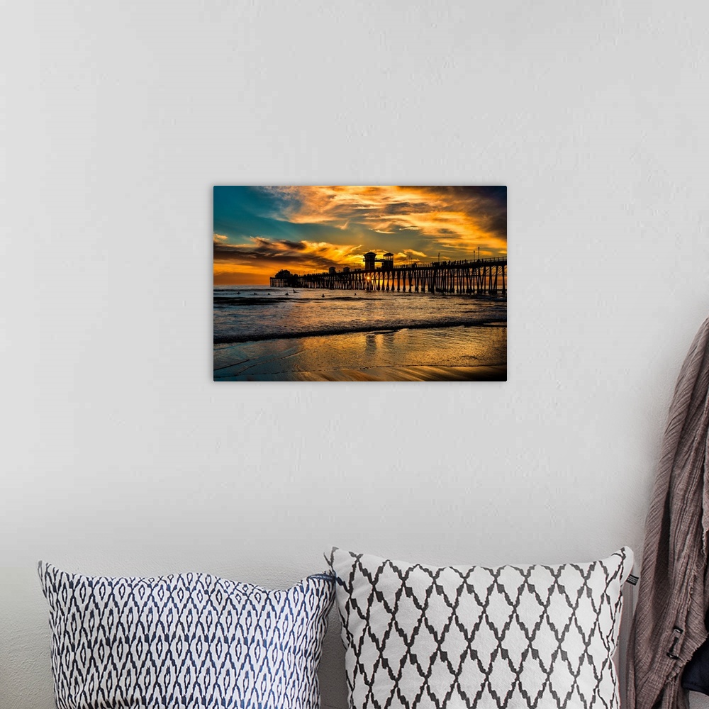 A bohemian room featuring Surfers near a Southern California Pier, the Oceanside Pier.