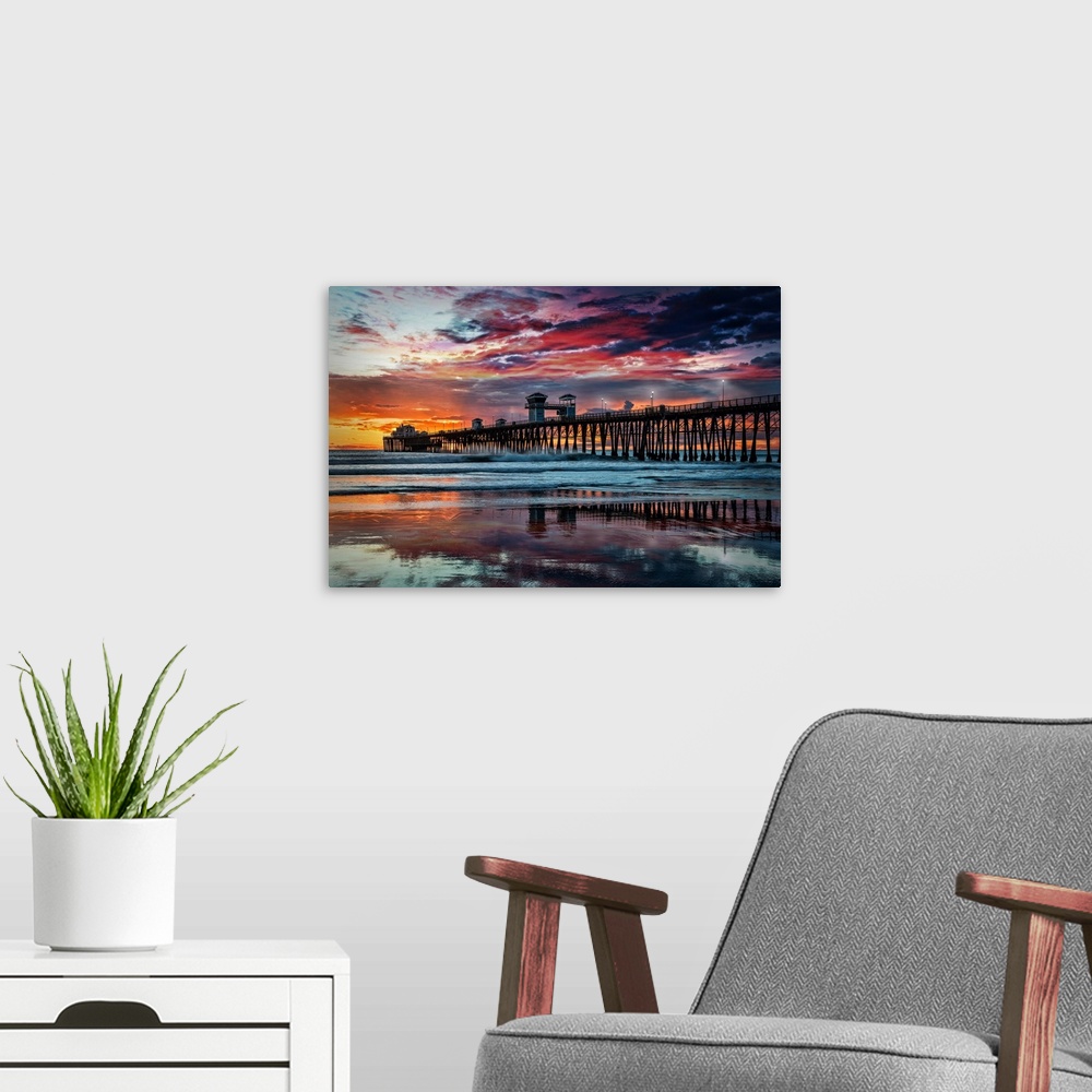 A modern room featuring Summer sunset at the Oceanside Pier. The Oceanside Pier is silhouetted as sunset turns the reflec...