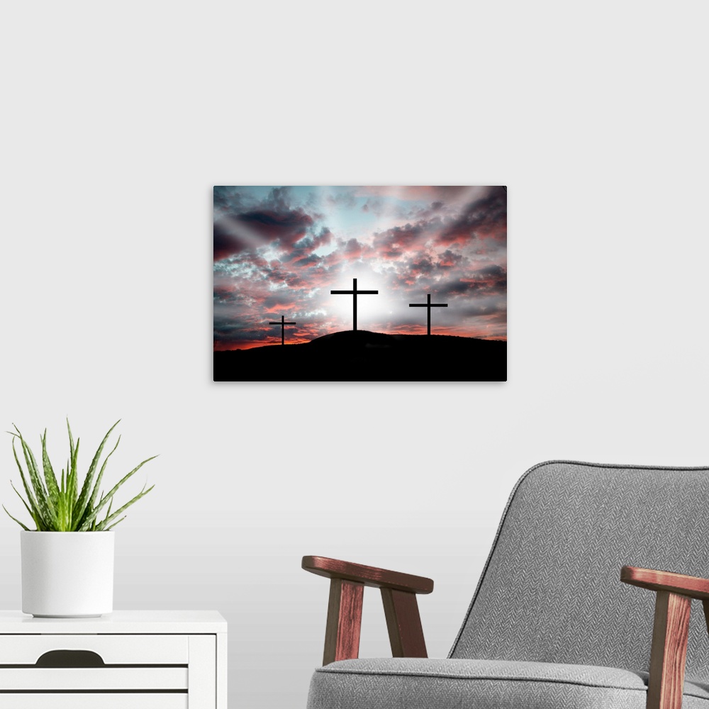 A modern room featuring Three crosses on a hillside. Dramatic light announcing the resurrection.