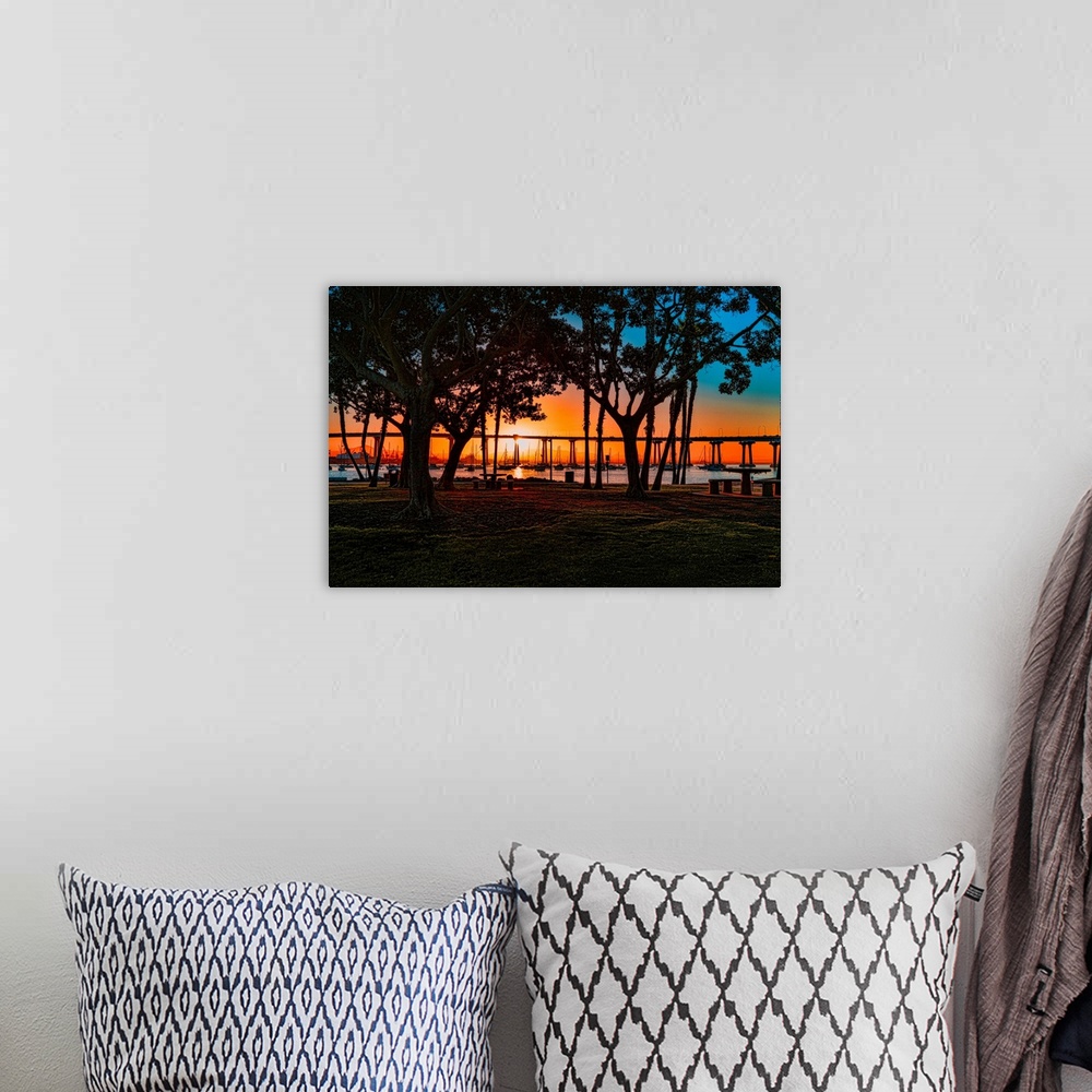 A bohemian room featuring A colorful view of San Diego Bay and Coronado Bay Bridge through trees on Coronado Island.