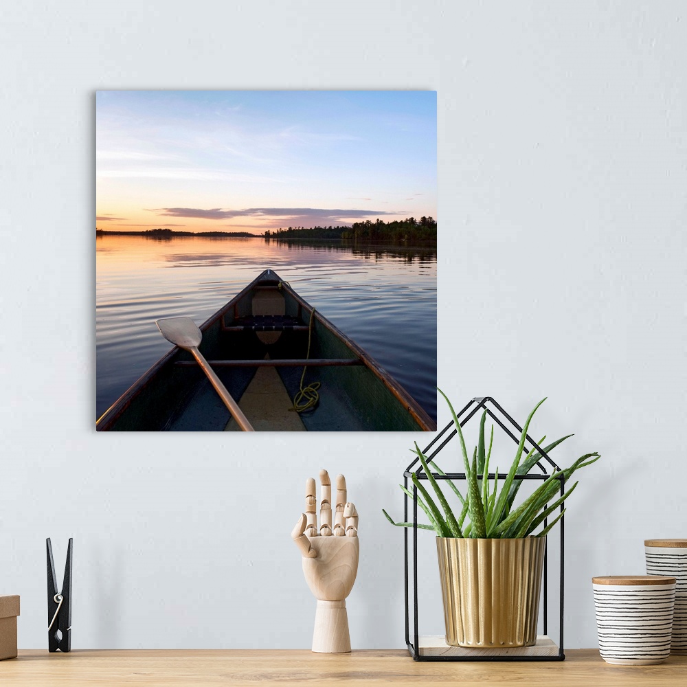 A bohemian room featuring A Boat And Paddle On A Tranquil Lake At Sunset, Ontario, Canada