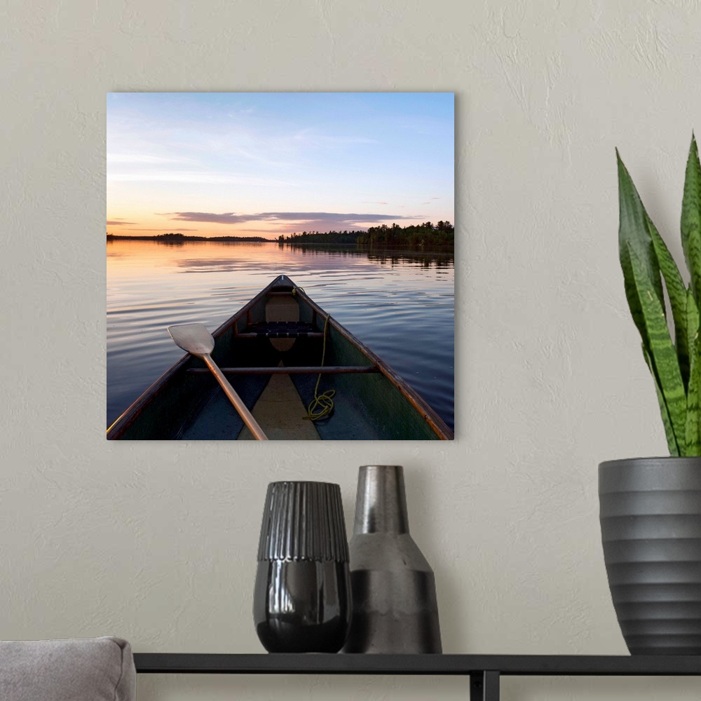 A modern room featuring A Boat And Paddle On A Tranquil Lake At Sunset, Ontario, Canada