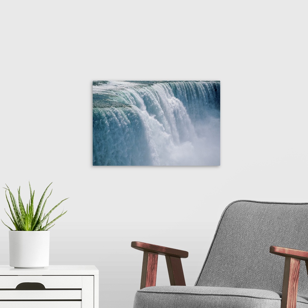 A modern room featuring Photograph taken of an immense waterfall in Niagara Falls.