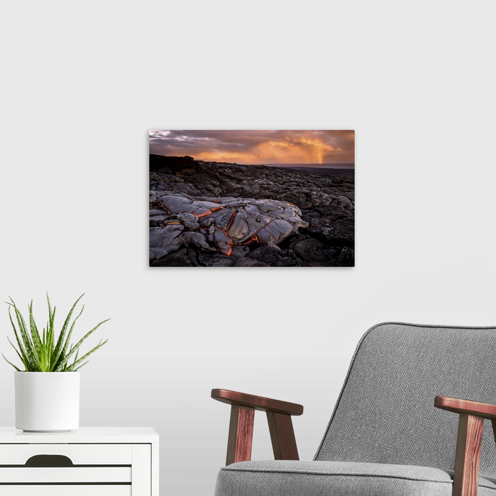 A modern room featuring A cooling lava flow on Kilauea, and distant rainbow over the water.