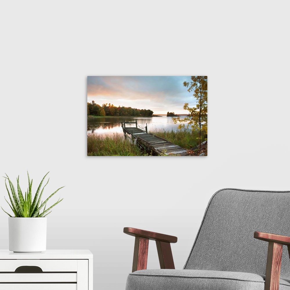 A modern room featuring A Dock On A Lake At Sunrise Near Wawa; Ontario, Canada