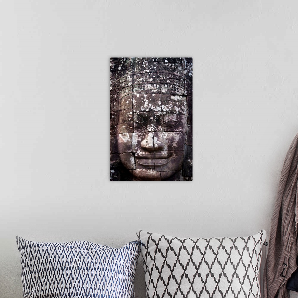 A bohemian room featuring A face sculpture on a stone wall at angkor wat, Cambodia