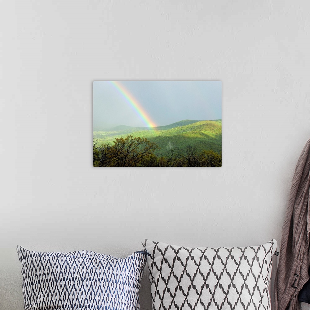 A bohemian room featuring A large rainbow over the Shenandoah Valley in late afternoon.