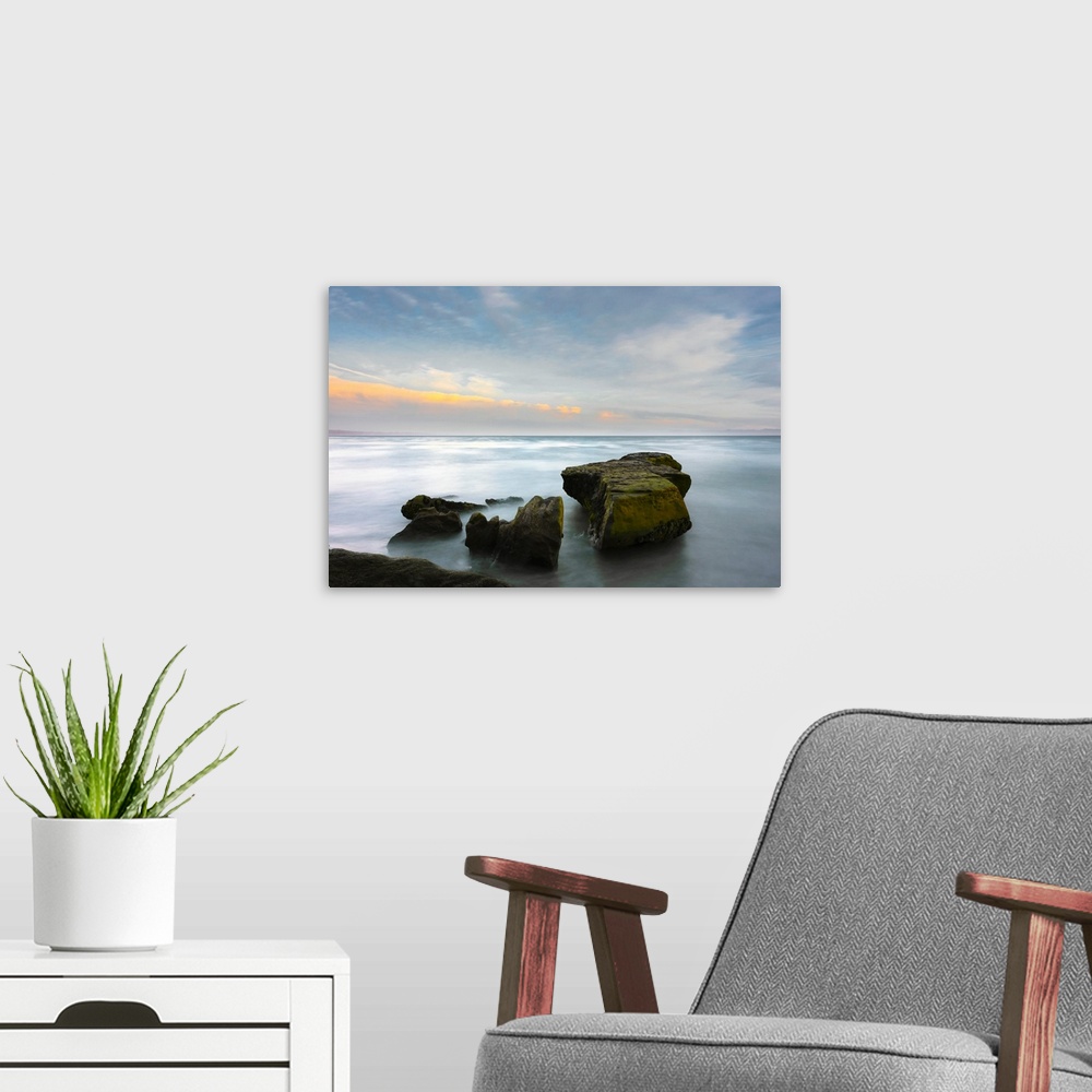 A modern room featuring A long exposure seascape made along a rocky beach in Santa Cruz, California, United States of Ame...
