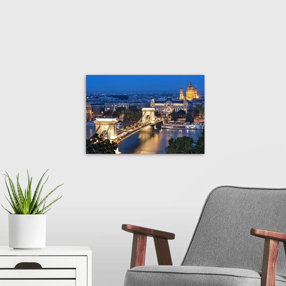 A modern room featuring A night view of Szechenyi Chain Bridge over the Danube River in Budapest.