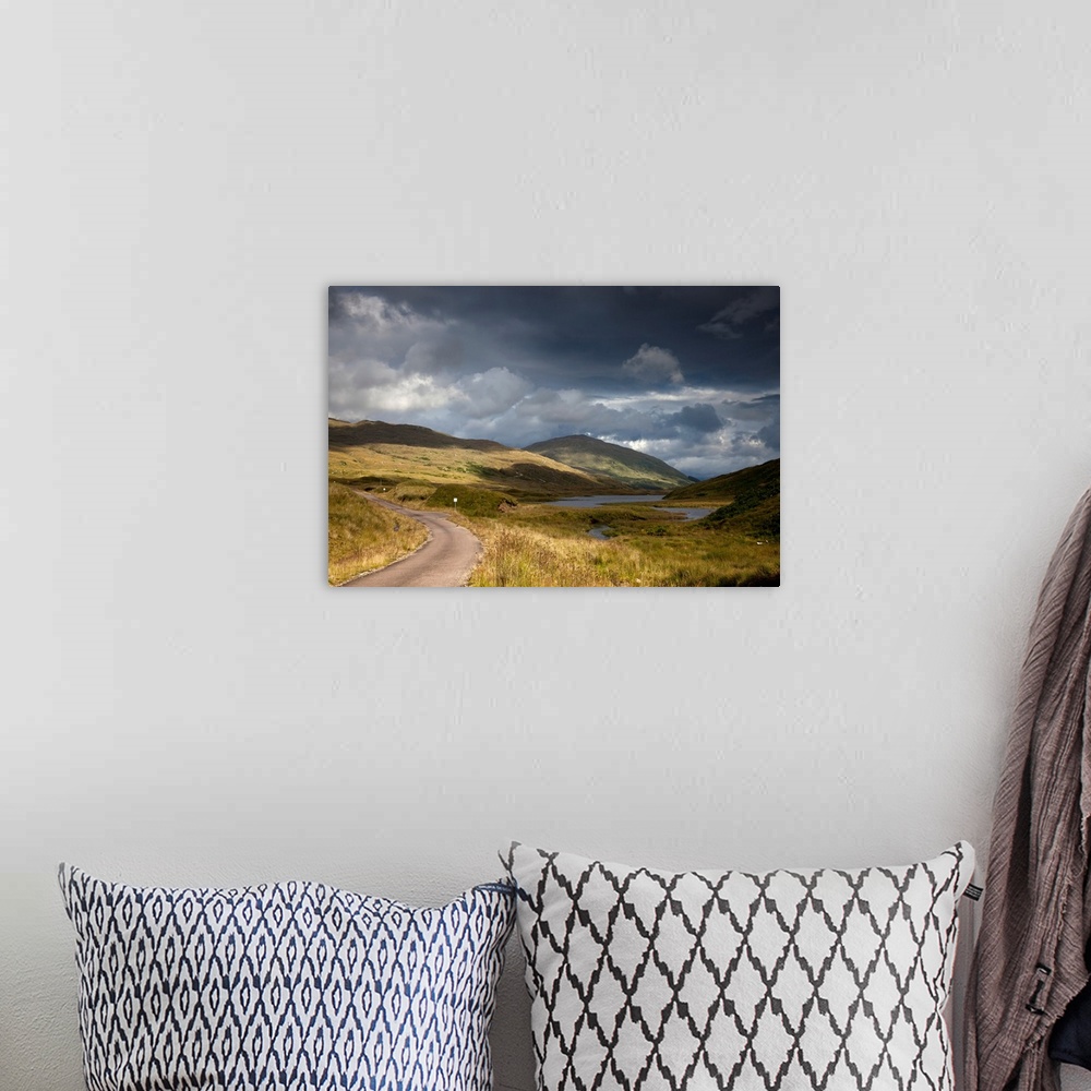 A bohemian room featuring A Road Curving Through A Mountainous Landscape. Ardnamurchan, Argyl, Scotland.