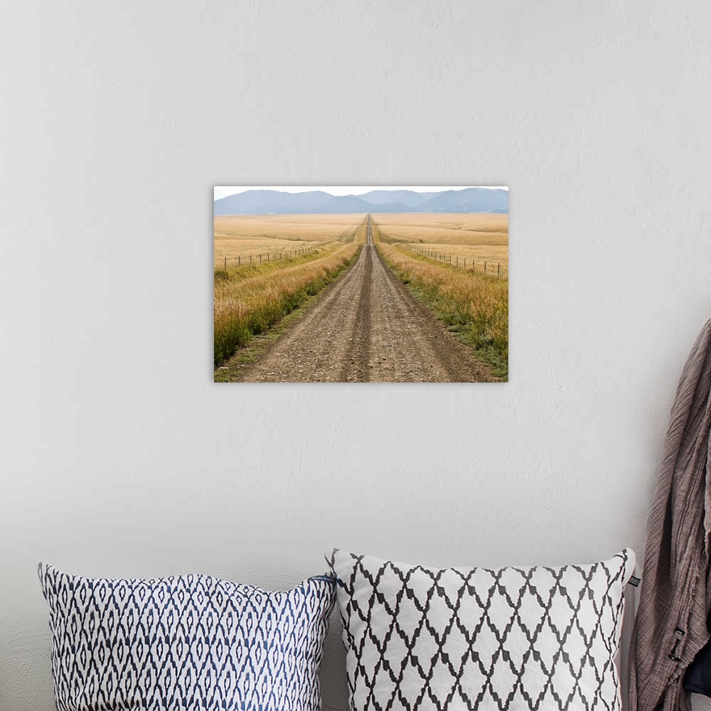 A bohemian room featuring A road cuts through a prairie in the Crazy Mountains.