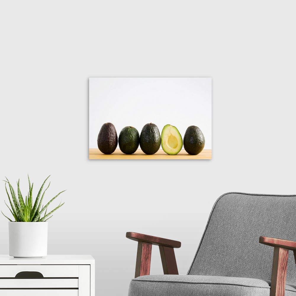 A modern room featuring A Row Of Avocados With Interior Of One Showing Standing Upright