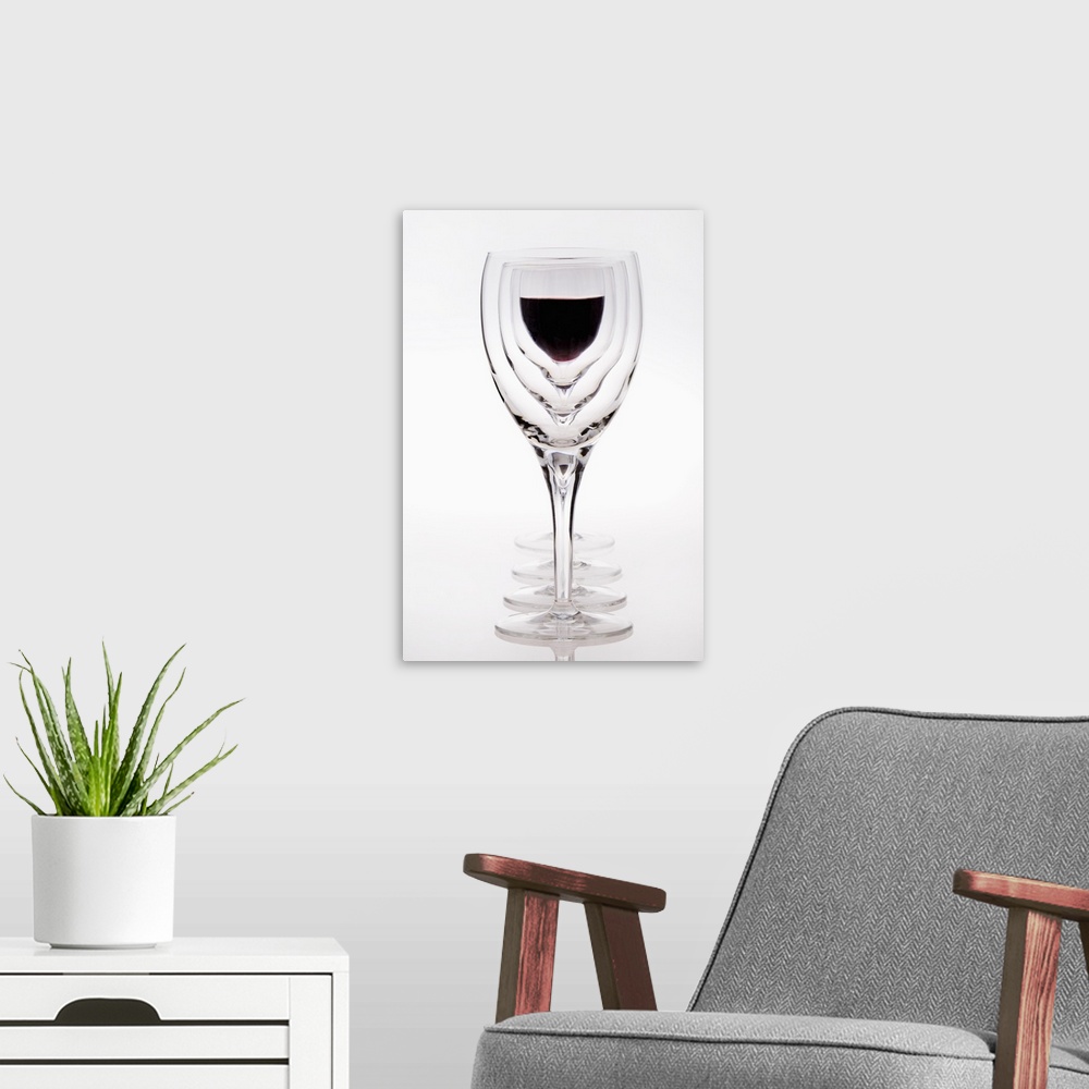A modern room featuring A Row Of Wine Glasses With Red Wine In The Last Glass