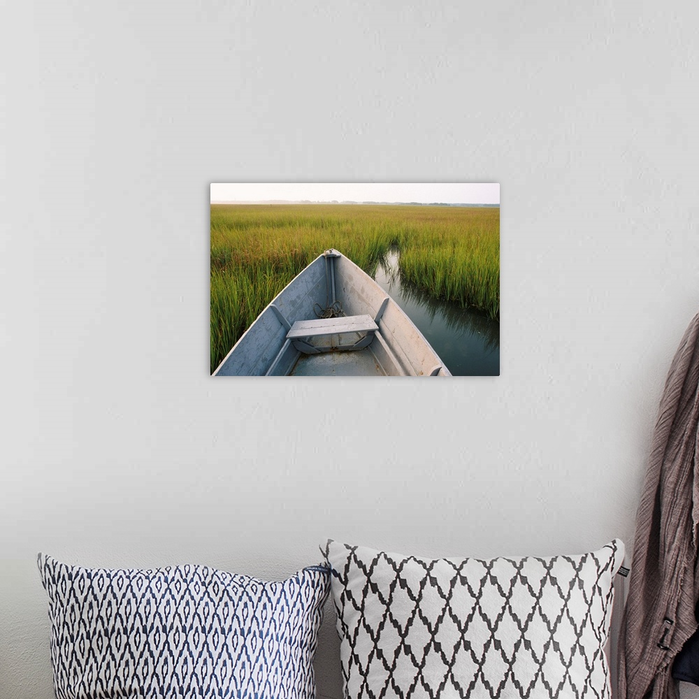 A bohemian room featuring A rowboat rests in the marsh of Assateague Island.