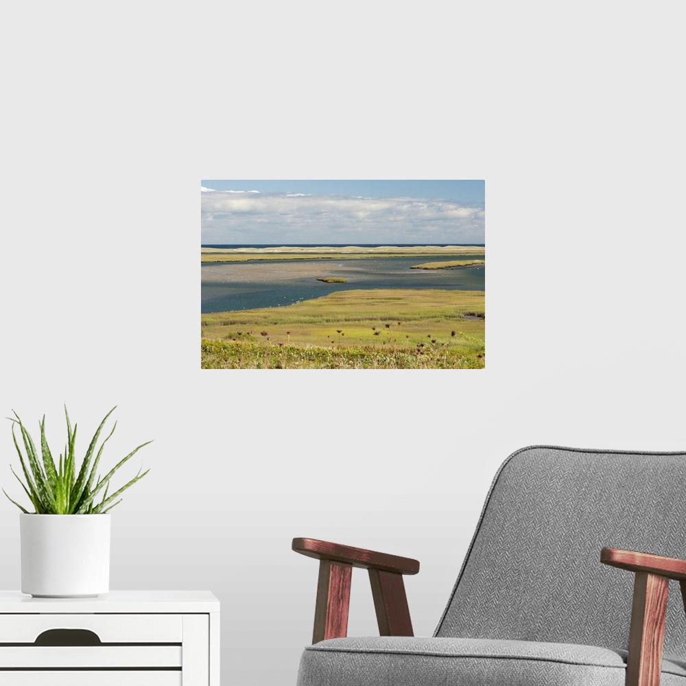 A modern room featuring A scenic view of a coastal marsh and barrier island. Fort Hill, Eastham, Cape Cod, Massachusetts.