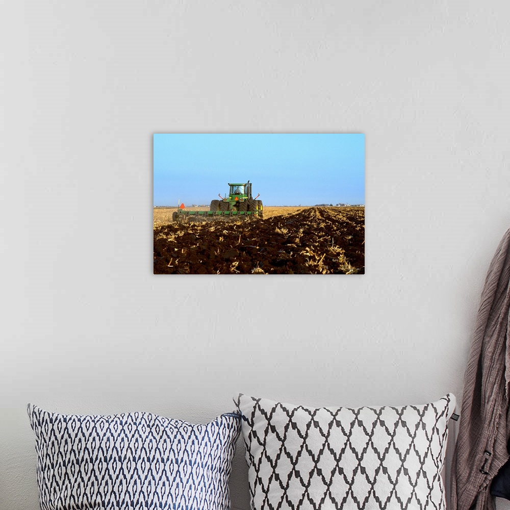 A bohemian room featuring A tractor and field implement preparing the field for overwintering