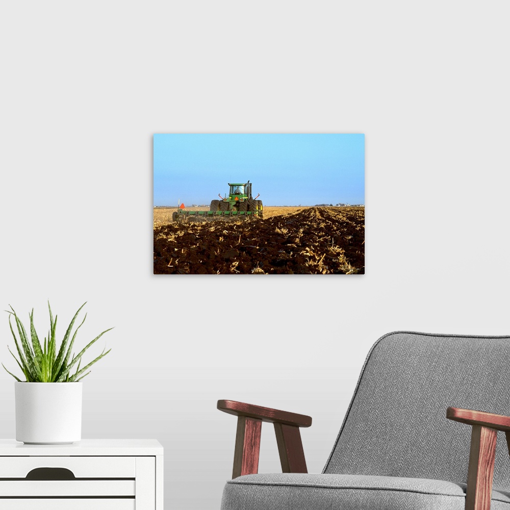 A modern room featuring A tractor and field implement preparing the field for overwintering