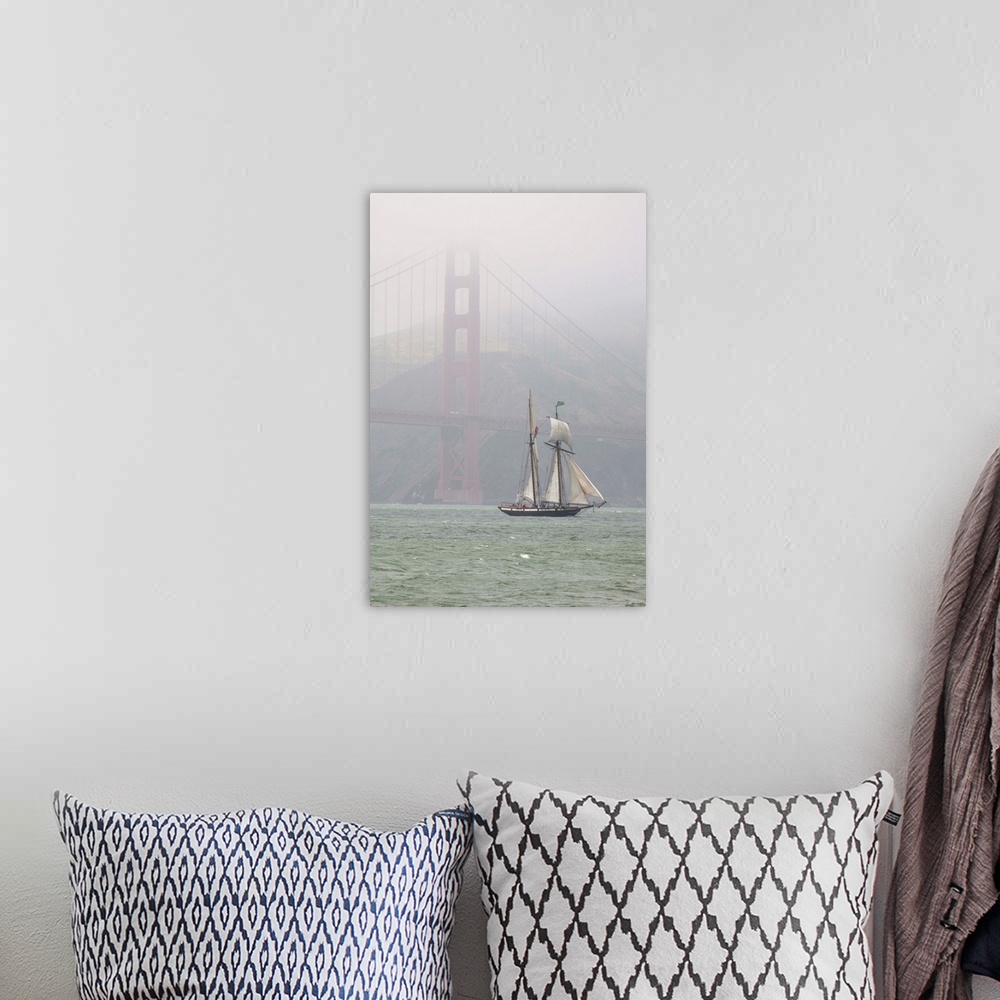 A bohemian room featuring A two masted schooner sails under the Golden Gate Bridge.