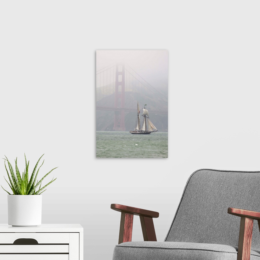 A modern room featuring A two masted schooner sails under the Golden Gate Bridge.