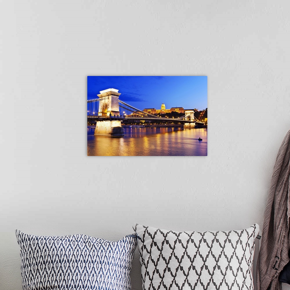 A bohemian room featuring A view of the Chain Bridge over the river Danube at night.