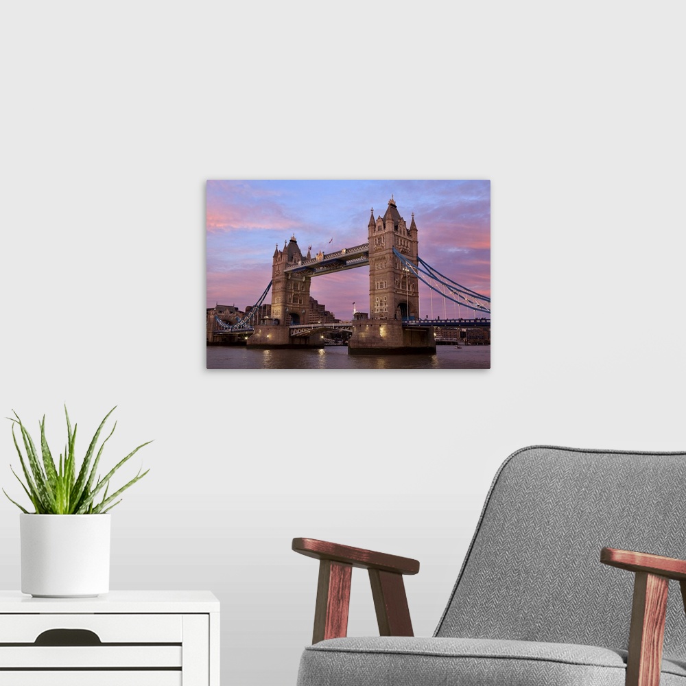 A modern room featuring A view of Tower Bridge at sunset.