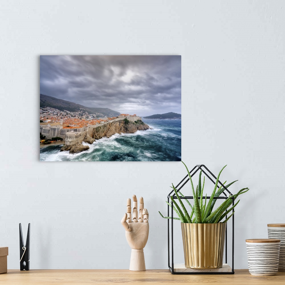 A bohemian room featuring A view towards Dubrovnik Old Town with stormy seas below the city walls.