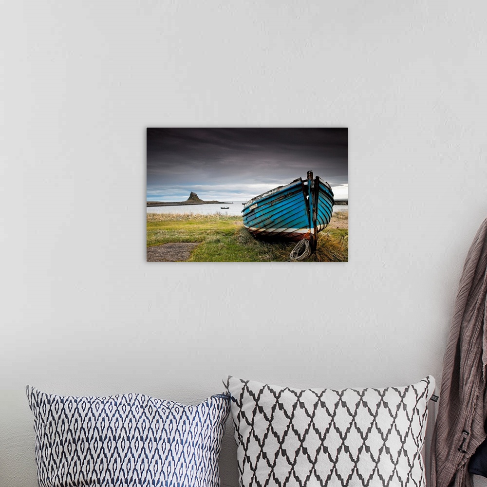 A bohemian room featuring A Weathered Boat Sitting On The Shore, Northumberland, England