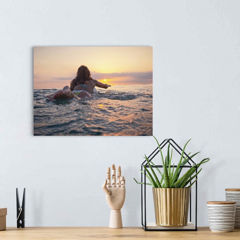 A bohemian room featuring A Woman Laying On A Surfboard Watching The Sunset, Andalusia, Spain