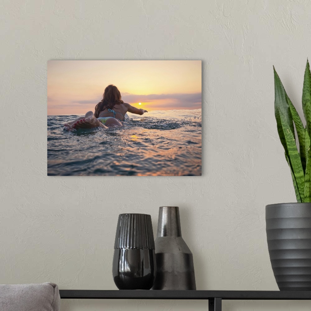 A modern room featuring A Woman Laying On A Surfboard Watching The Sunset, Andalusia, Spain